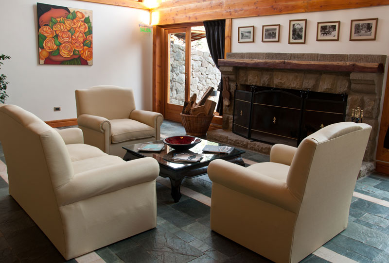 Living con sillones y hogar a leña
